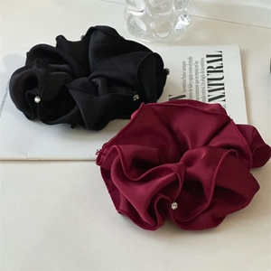 Detail of premium black and wine red satin scrunchies with delicate rhinestone accents