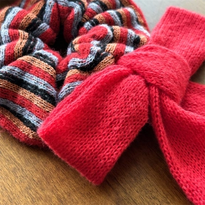 Premium red knit scrunchie and bow hair tie set on a natural wood surface for autumn style