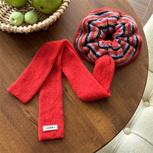 Elegant red knit striped scrunchie with long ribbon bow and white nice label accent