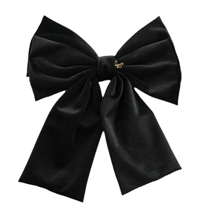 Elegant large black velvet double-layer bow hair clip with gold metal tag on white background