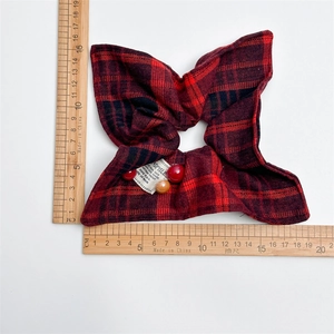 Red plaid scrunchie with beads shown on white background with measuring rulers