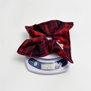 Classic red plaid scrunchie with beads and tags on a scale weighing 29.2 grams