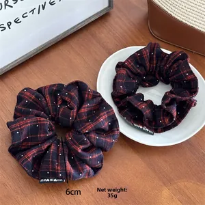 Detail view of French vintage red plaid scrunchie with 6cm diameter and premium branding