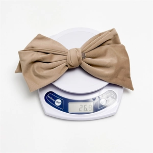 Brown velvet bow hair clip with vintage silver buckle weighing 26.9g on scale