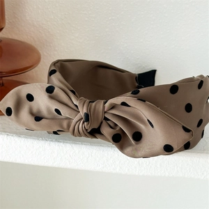 Detail of coffee brown polka dot bow headband with silky texture and vintage french style