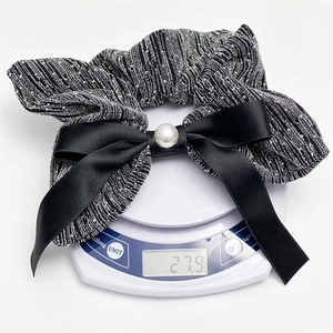 Luxe black and white knitted scrunchie with large satin bow and pearl accent weighing 27.9g