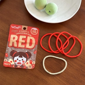 Lot d'élastiques à cheveux rouges et dorés avec sachet cadeau festif sur bois
