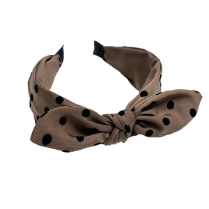 Elegant brown polka dot headband with large bow tie, stylish hair accessory for women