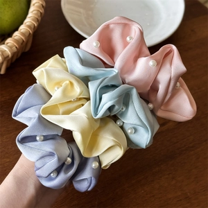 Lot de quatre chouchous en satin avec perles aux couleurs pastel sur poignet