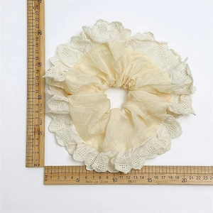 Beige satin scrunchie with white lace trim and 20cm diameter size measurement