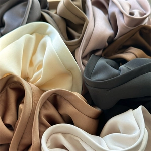 Detailed close-up showing satin fabric texture and earthy color tones of oversized scrunchies