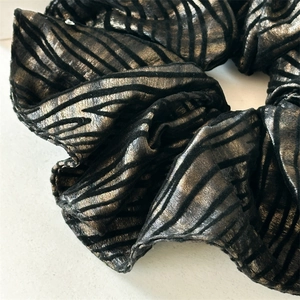 Chic scrunchie with irregular metallic bronze and black stripes for vintage hair styling