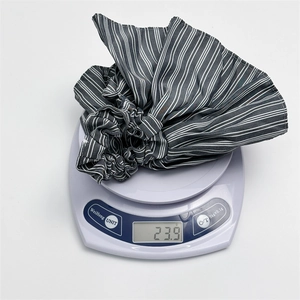Elegant black and white striped oversized scrunchie hair tie weighing 23.9 grams