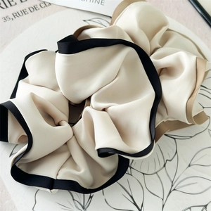 Elegant oversized satin scrunchie in beige with black and brown contrast trim
