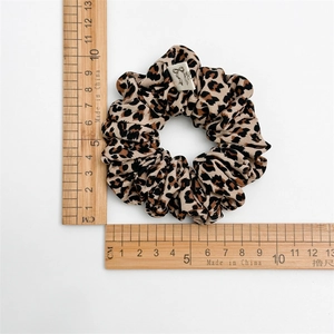 Leopard print scrunchie hair tie with woven label, medium size 10cm diameter overview