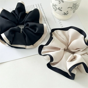Elegant two-pack contrast scrunchies in black and beige silk satin for hair styling