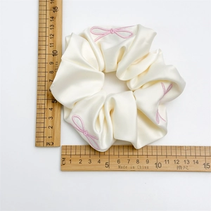 Elegant cream satin scrunchie with pink bow embroidery and 12cm diameter size