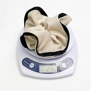 Detail showing the 24.5g weight of this elegant silk scrunchie with black trim