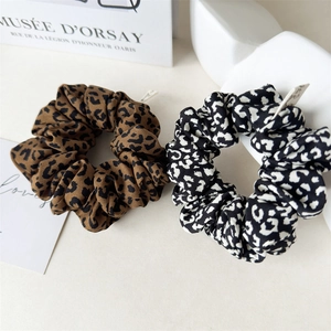 Close-up of leopard print hair scrunchies set with silky texture and premium patterns