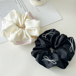 Elegant satin scrunchies in black and white with delicate butterfly embroidery for women