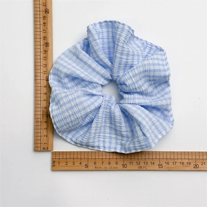 Blue and white checkered oversized scrunchie hair tie with natural pleated cotton fabric