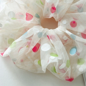 Macro detail of 18cm off-white mesh scrunchie with vibrant multi-color polka dots