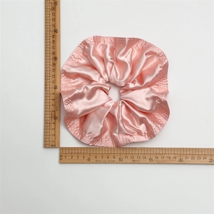 Pink satin scrunchie detail showing 13cm diameter size with ruler measurement