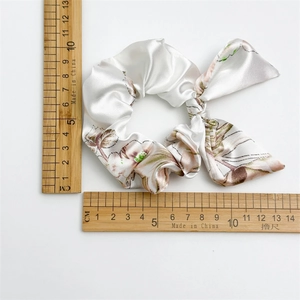 Floral satin hair scrunchie with long ribbons and measuring scale for size reference