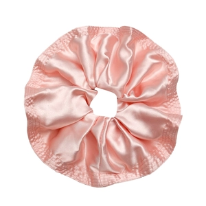 Oversized bright pink satin hair scrunchie with ruffled texture and silk gloss finish