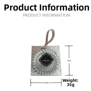 Détail de l'ensemble d'élastiques spirales pour cheveux, dimensions 7cm x 6.5cm en boîte