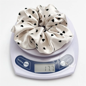 Elegant white satin heart print scrunchie hair tie weighing 17.7g on a scale
