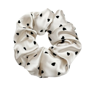 Elegant beige satin scrunchie with black heart pattern and premium silky texture
