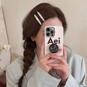 Gros plan d'une pince à cheveux crème minimaliste portée avec accessoires de mode