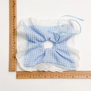 Blue and white plaid scrunchie with white lace trim and blue ribbon bow accessory