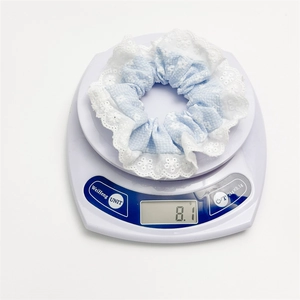 Floral lace scrunchie with blue plaid fabric and embroidery, weighing 8.1 grams