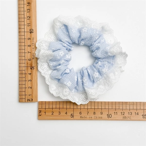 Floral lace hair scrunchie in light blue gingham fabric with white lace edge detailing