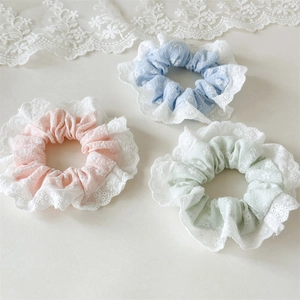Three-piece set of floral lace hair scrunchies in pastel pink, blue, and green colors
