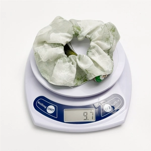 Ink floral scrunchie in light green fabric with bead tassel, weighing 9.7g on scale