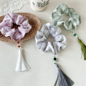 Detail of floral chiffon hair scrunchies with elegant bead and silk tassel charms