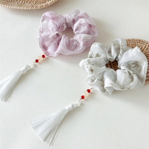 Ink marble pattern scrunchies with long silk tassels and decorative bead details