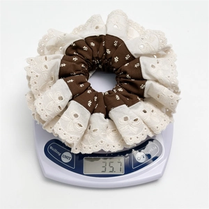 Floral fabric and lace embroidery scrunchie accessory weighing 35.7g on scale