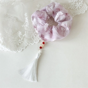 Detail of lavender floral scrunchie with white silk tassels and elegant beads