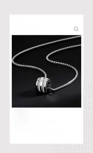 Detail of silver box chain necklace with zircon-encrusted cylinder bead for men