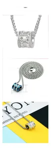 Detail view of cylinder pendant necklace with zircon inlays and dimensions on card