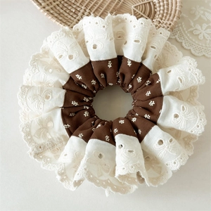 Detail of floral scrunchie with cream eyelet lace embroidery and brown print fabric