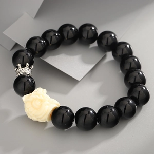 Obsidian bead bracelet with white mythical creature and silver crown charm detail
