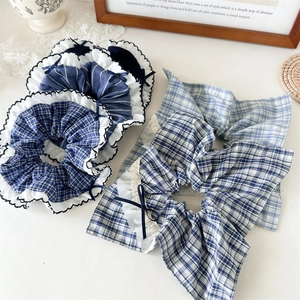 Blue plaid scrunchies with elegant lace edges and ribbons for stylish ponytails