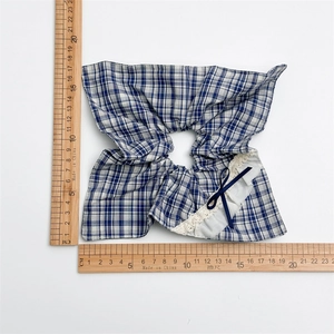 Blue plaid oversized hair scrunchie with white lace trim and dark blue satin bow detail