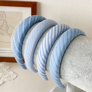 Detail of blue and white plaid fabric headbands with delicate rhinestone accents