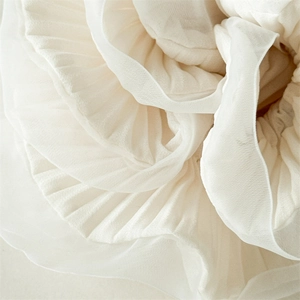 Detailed macro shot of white organza fabric with pleated edges for hair scrunchie accessory